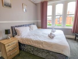 A bedroom with a bed and dresser at Fern Lee in Carlisle