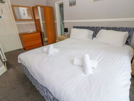 A bedroom with a double bed and wooden furniture at Fern Lee in Carlisle