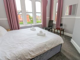 A bedroom with a bed and a chair at Fern Lee in Carlisle
