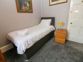 A bedroom with a single bed and nightstand at Fern Lee in Carlisle