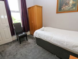 A bedroom with a single bed and wardrobe at Fern Lee in Carlisle