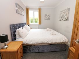 A bedroom with a bed and window at Fern Lee in Carlisle