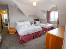 A bedroom with two beds and a dresser at Fern Lee in Carlisle