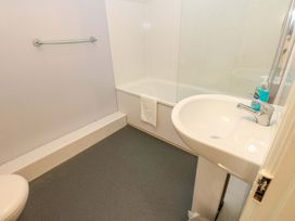 A bathroom with a bathtub, sink, and toilet at Fern Lee in Carlisle