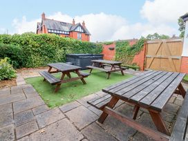 An outdoor area with picnic tables and a hot tub at Fern Lee in Carlisle