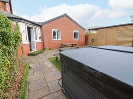 A garden with a hot tub and seating area at Fern Lee in Carlisle