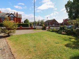 A garden area with grass and tree at Fern Lee in Carlisle