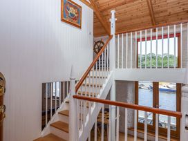 A staircase and wall with artwork in a hallway at Dolphin Cottage in Brixham