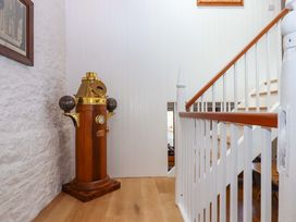 An entryway with a decorative object and staircase at Dolphin Cottage in Brixham