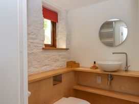 A bathroom with a sink and mirror at Dolphin Cottage in Brixham