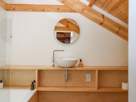 A bathroom with a sink and mirror at Dolphin Cottage in Brixham