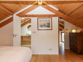 A bedroom with a bed and a door leading to another room at Dolphin Cottage in Brixham