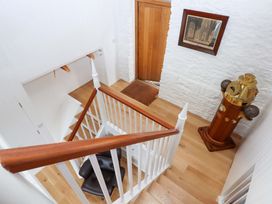 A staircase with a chair and decorative object at Dolphin Cottage in Brixham
