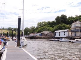 A marina with boats at a dock near buildings at Dolphin Cottage in Brixham