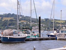 Boats moored at a dock with hills in the background at Dolphin Cottage in Brixham