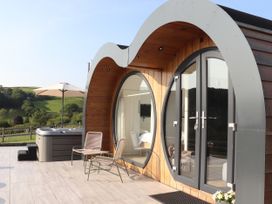An outdoor area featuring a hot tub and seating at Ceunant, Llanfihangel-y-Creuddyn near Aberystwyth