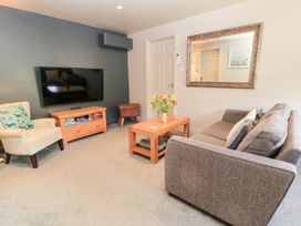 A living room with a sofa and television at Well Cottage Nr Malmesbury
