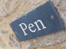 A sign reading 'Pen' on a stone wall at Carines Barns - Pen, Cubert