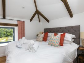 A bedroom with a bed and window at Carines Barns - Pen in Cubert