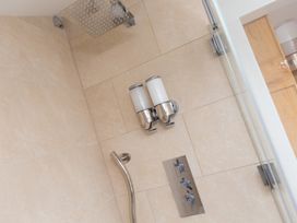 A shower with controls and soap dispenser at Carines Barns - Pen, Cubert