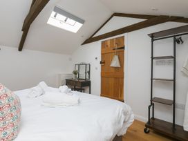 A bedroom with a bed and a dresser at Carines Barns - Pen, Cubert