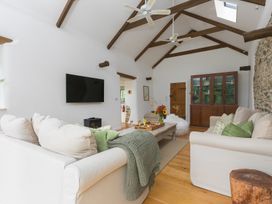 A living room with a sofa and coffee table at Carines Barns - Wesley Barn in Cubert
