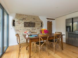 A kitchen with a wooden table and chairs at Carines Barns - Wesley Barn, Cubert