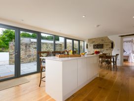 A kitchen with a large island and dining area at Carines Barns - Wesley Barn in Cubert