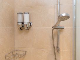 A shower with shampoo and conditioner dispensers at Carines Barns - Wesley Barn, Cubert
