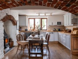 A kitchen with a table and chairs at Lower Mill in Dittisham