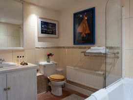 A bathroom with a sink, toilet, and bathtub at Lower Mill in Dittisham