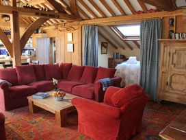 A living room with a sofa and coffee table at The Barn in Dittisham