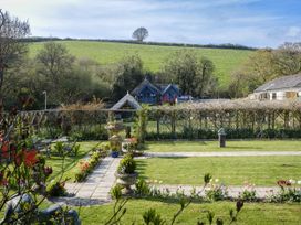 A garden with a fountain and flowers at The Barn in Dittisham