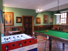 A recreation room with a foosball table and a pool table at The Barn in Dittisham