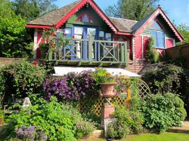 A house with a balcony and garden at The Folly in Dittisham