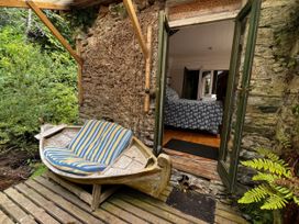 An outdoor area with a boat seat at The Folly in Dittisham