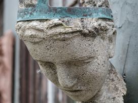 A sculpture of a head with a crown at The Folly in Dittisham