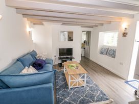 A living room with a sofa and coffee table at The Cottage in Ettington