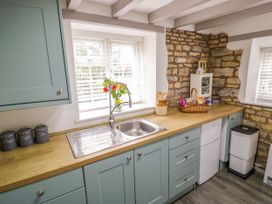 A kitchen with a sink and cabinets at The Cottage in Ettington