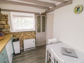 A kitchen with a table and chairs at The Cottage in Ettington