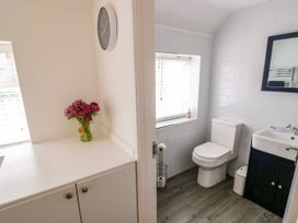 A bathroom with a toilet and a sink at The Cottage in Ettington