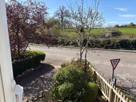 A view of trees and a road with a give way sign at The Cottage in Ettington
