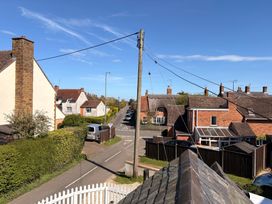 A view of a street with houses and a utility pole at The Cottage in Ettington