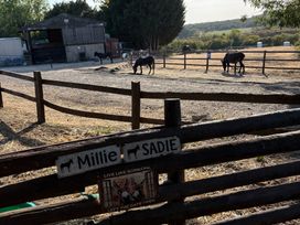 An outdoor area with horses and a barn at The Cottage in Ettington