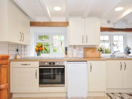 A kitchen with a refrigerator and an oven at Henwood Barn in Henwood near Upton Cross