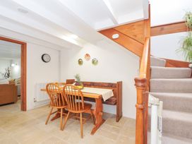 A dining area with a table and chairs at Henwood Barn Henwood near Upton Cross