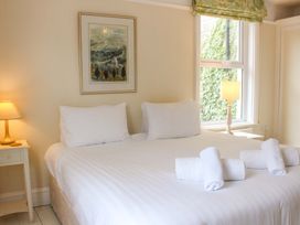 A bedroom with a bed and lamp at 29b Lower Street in Dartmouth