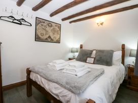 A bedroom with a bed and map at Ty'n-Y-Ffynnon Cottage Barmouth