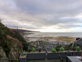 A view of the ocean and beach from a deck at Ty'n-Y-Ffynnon Cottage Barmouth