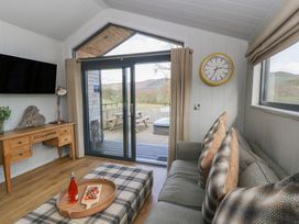 A living room with a sofa and television at Fawn’s Rest Nantmel near Rhayader